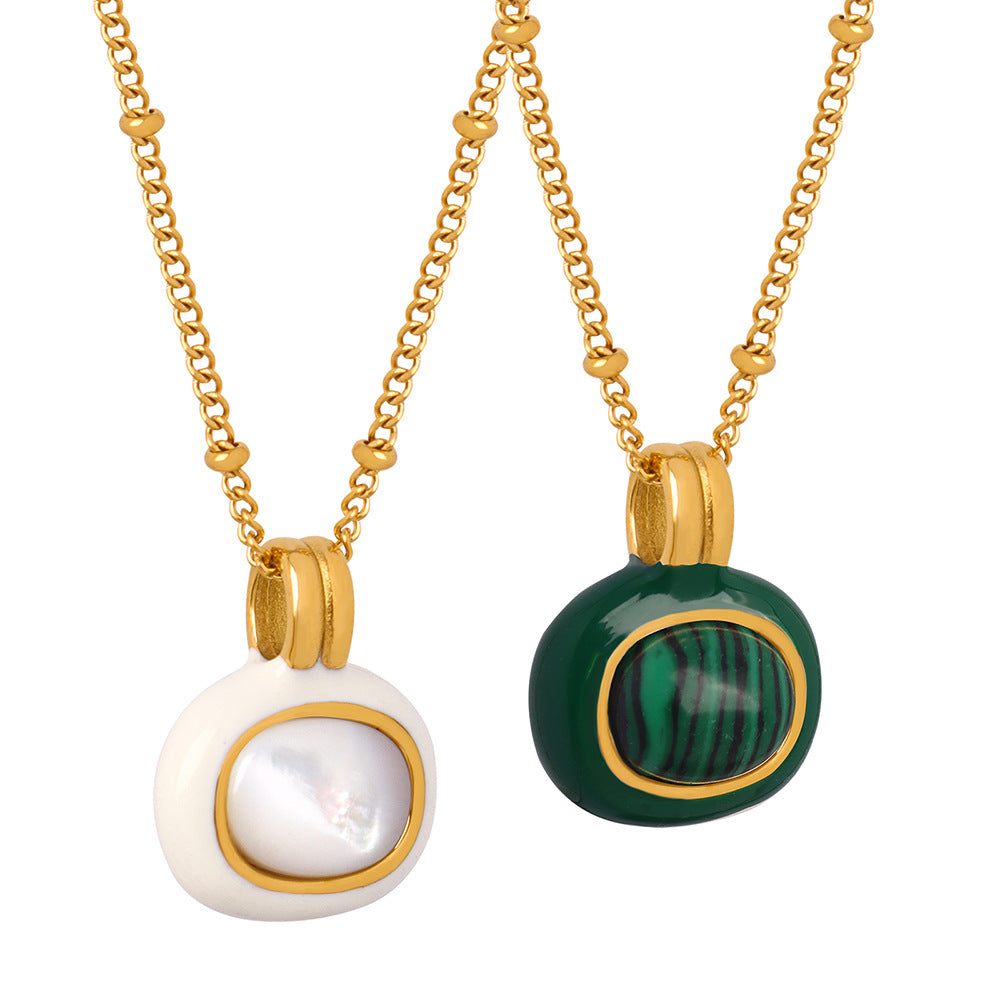 A gold-colored stainless steel women's necklace with two different beads, one with a green and black striped pattern and the other with a white pearl-like finish.