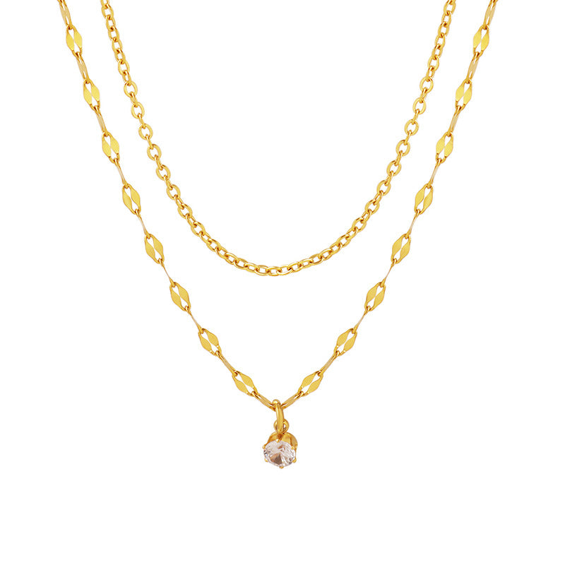 A gold-colored stainless steel women's necklace with a solitaire pendant.