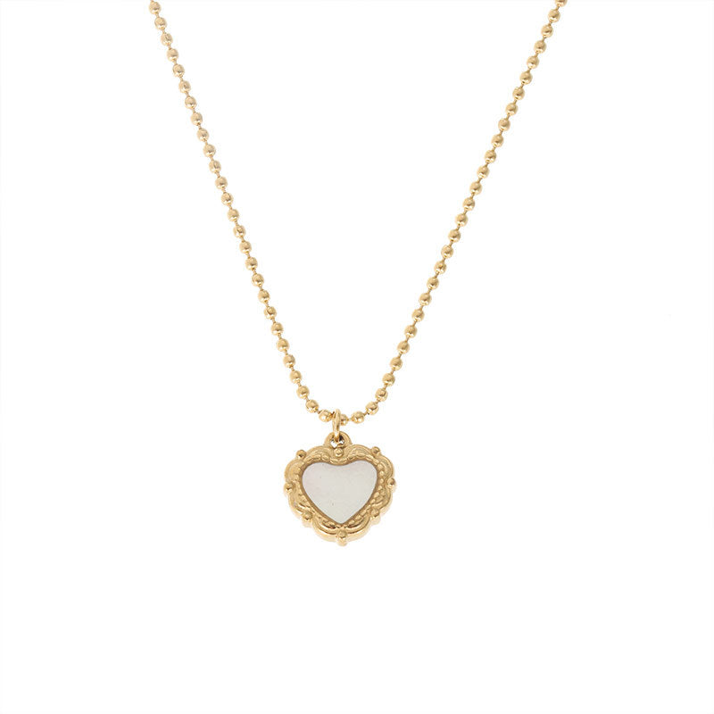 A gold-colored necklace with a heart-shaped pendant.