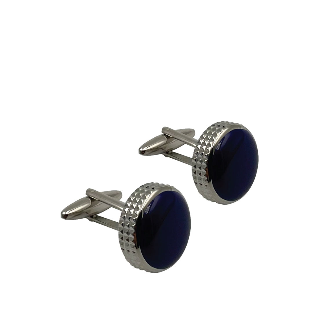 A pair of silver and black enamel cufflinks with a round shape and beveled edges.