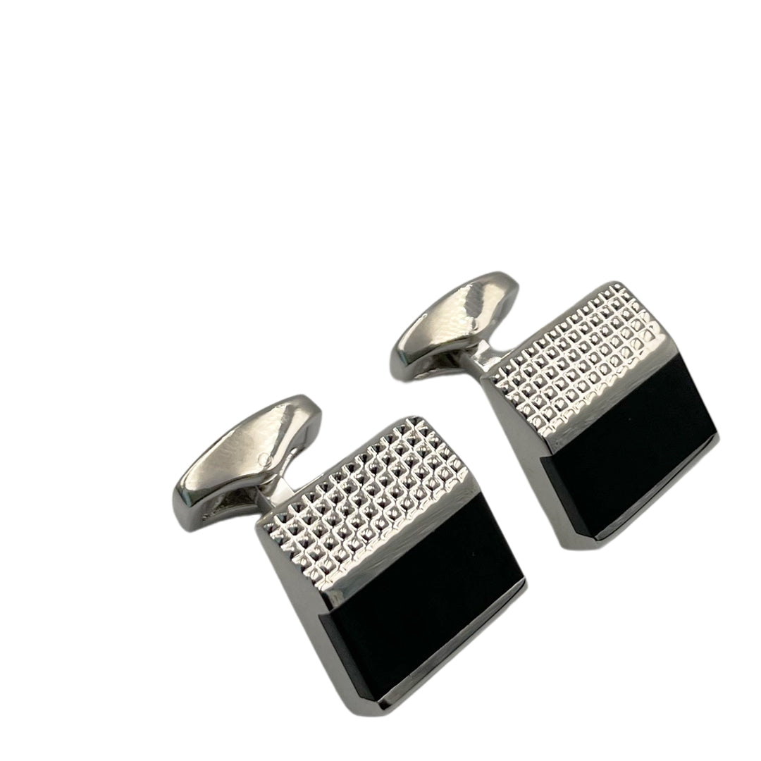 A pair of rectangular cufflinks with a black carbon fibre pattern and silver metallic finish.