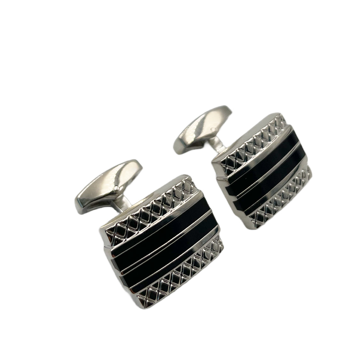 A pair of silver and black enamel cufflinks with a geometric pattern.