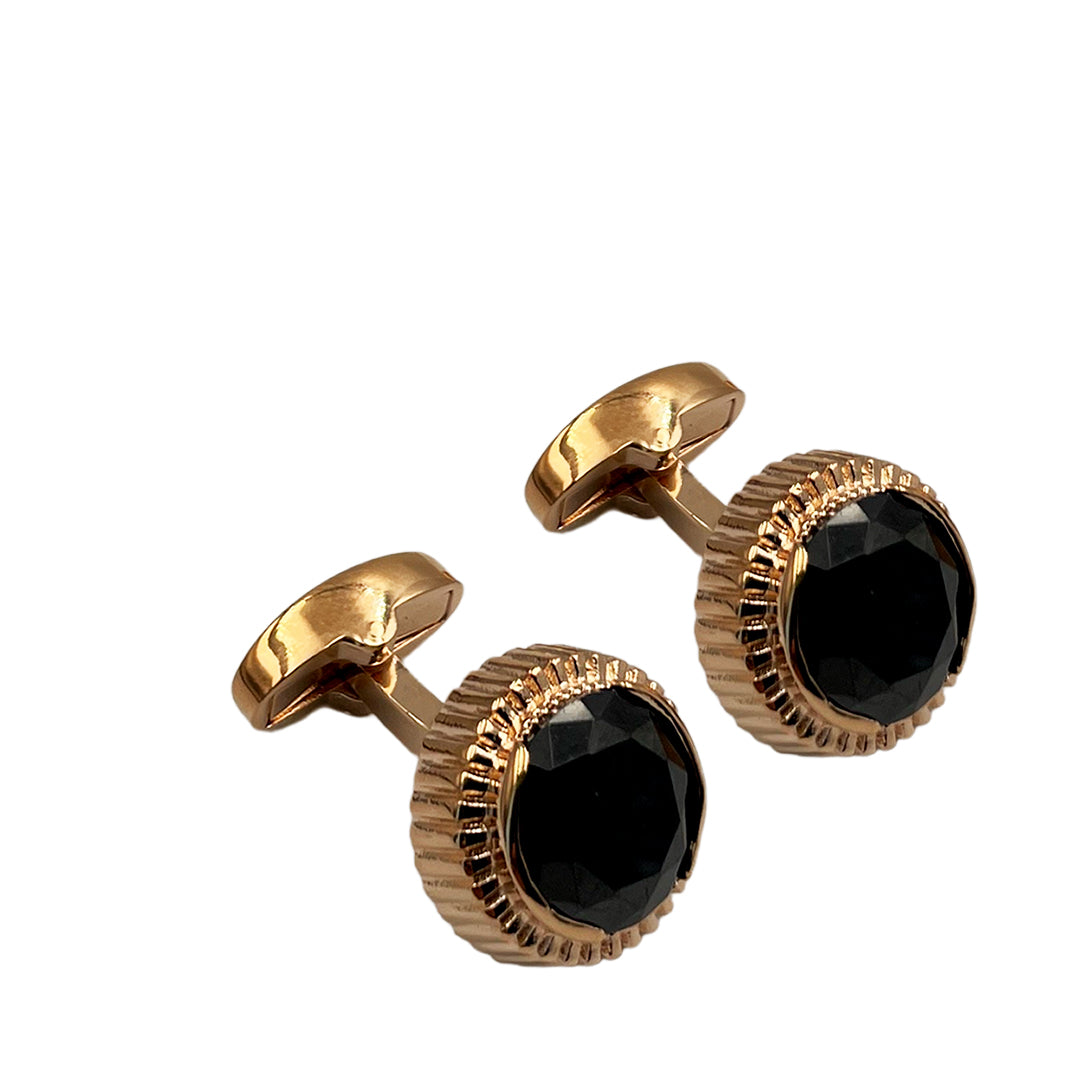 A pair of rose gold cufflinks with black zircon inlays.