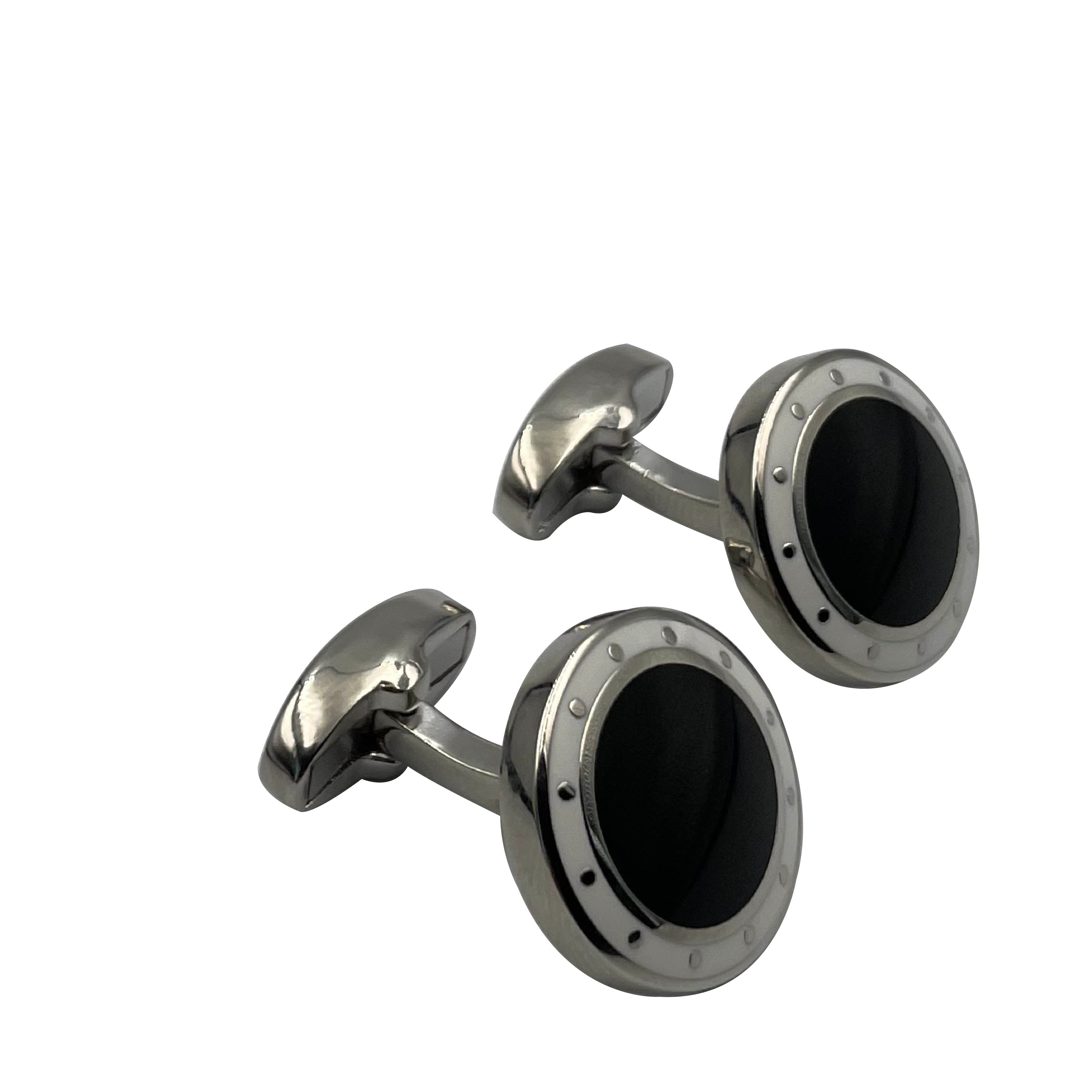 A pair of men's cufflinks with a metallic finish and black enamel detailing.