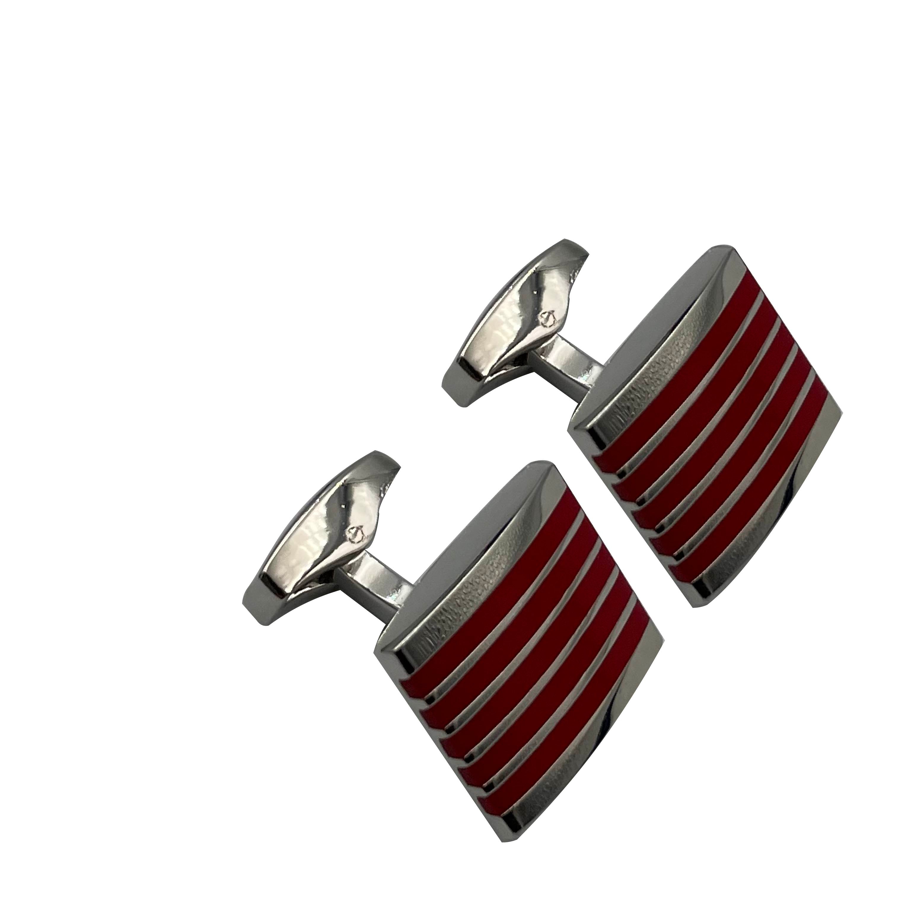 A pair of silver stainless steel cufflinks with red enamel stripes.
